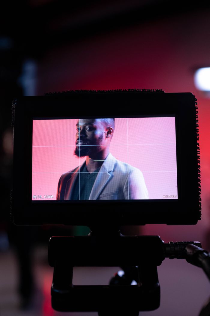 Portrait of a man on a monitor, capturing a behind-the-scenes film production moment.