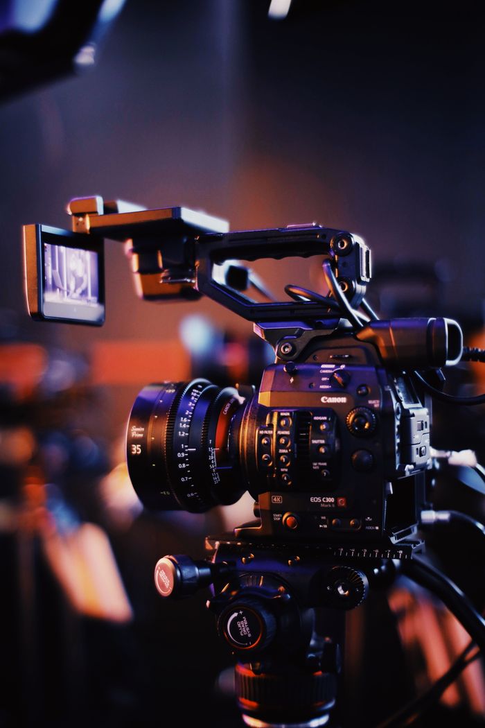 portfolio-08 Close-up of a professional video camera setup indoors, capturing high-quality footage.