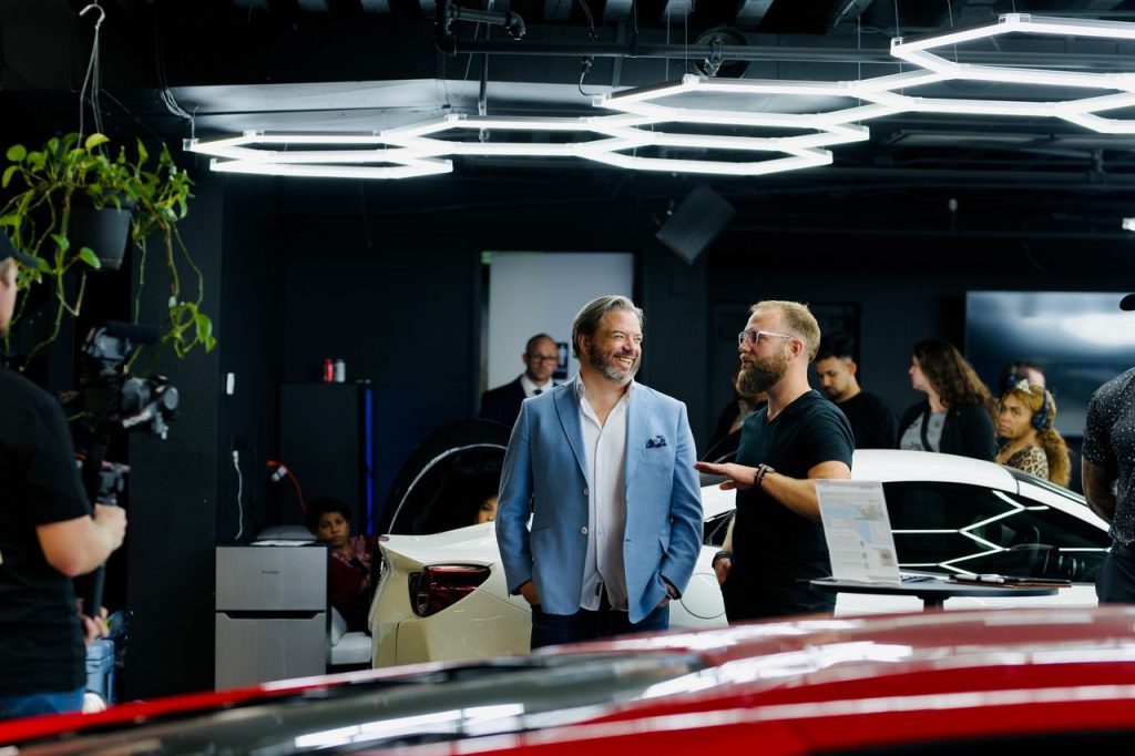 luxury-car-event-in-los-angeles-showroom-32538012 A luxury car event with attendees and videographers in a stylish Los Angeles showroom.