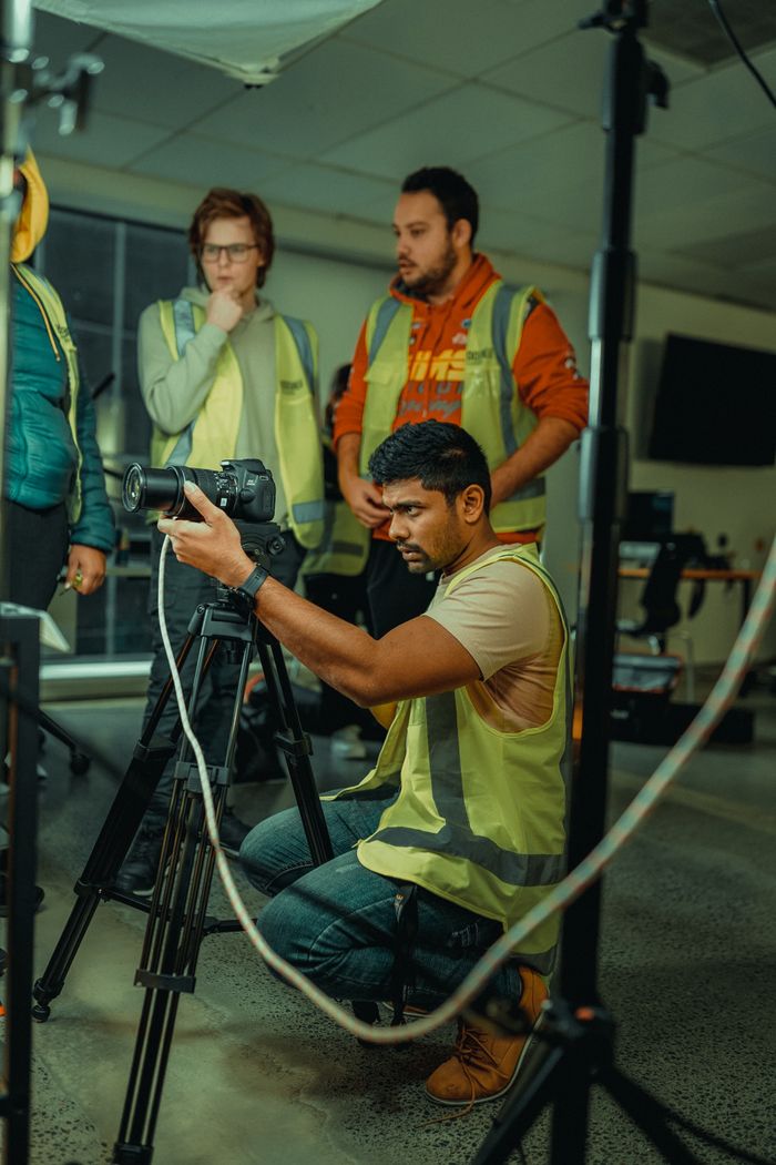 Mastering the First Impression: Your intriguing post title goes here Film crew setting up camera equipment indoors, discussing scene setup and shot composition.